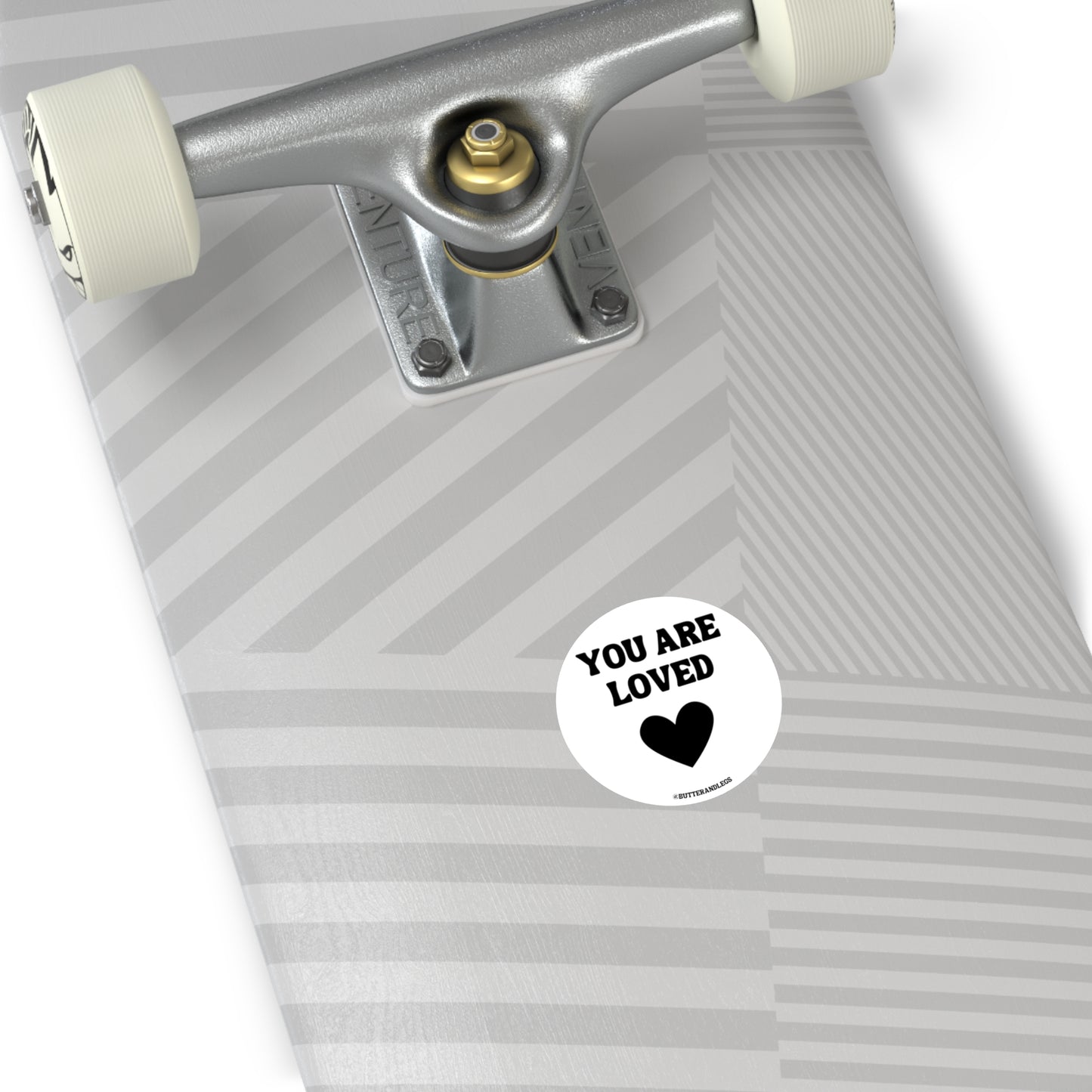 WHITE STICKER WITH BLACK TEXT THAT READS "YOU ARE LOVED" WITH A HEART