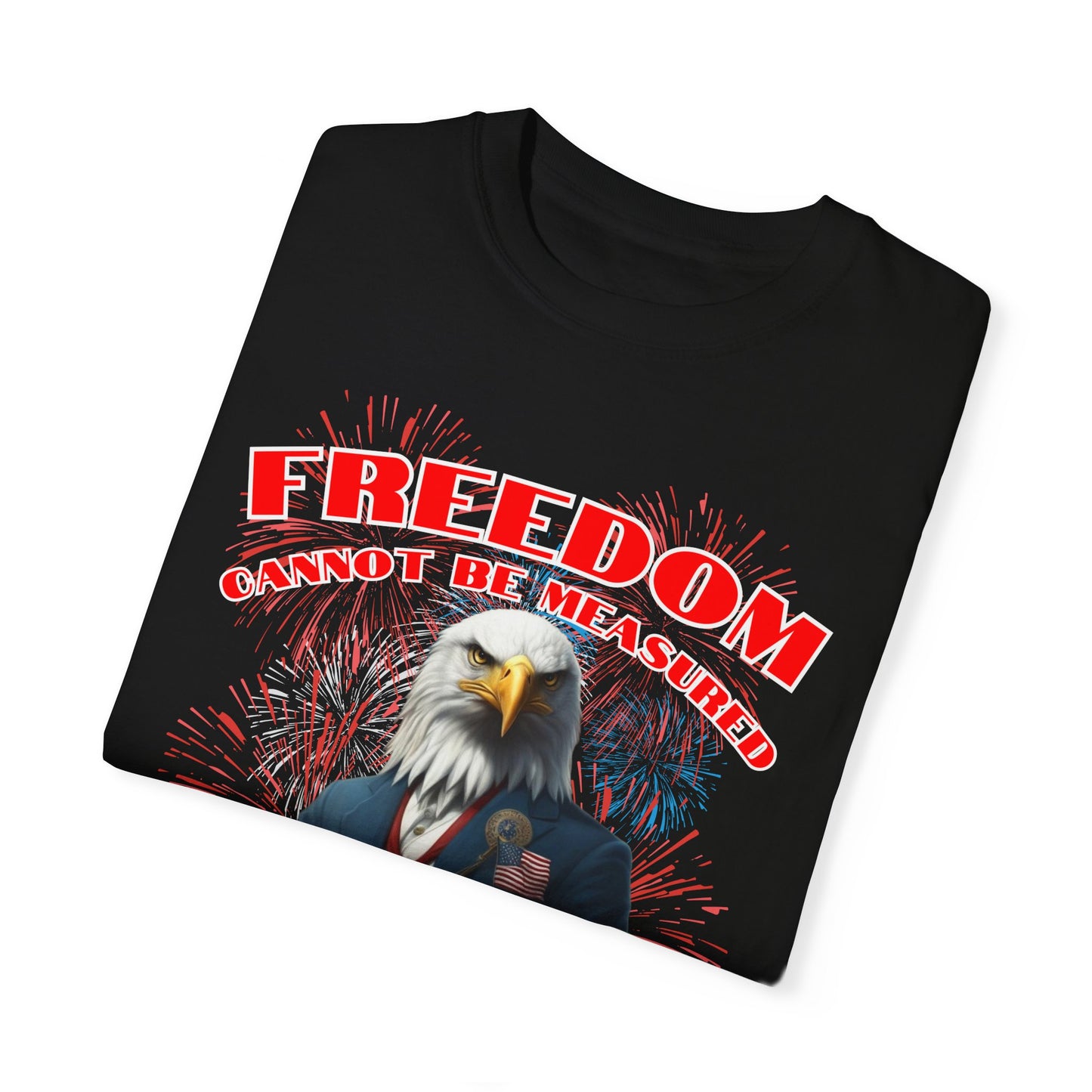 4TH OF JULY / INDEPENDENCE DAY T-SHIRT FEATURING A HUMANIZED BALD EAGLE HOLDING A TINY BALD EAGLE WITH THE WORDS "FREEDOM CANNOT BE MEASURED BY THE METRIC SYSTEM" AND A BACKGROUND OF FIREWORKS. IT'S FESTIVE. IT'S PATRIOTIC.