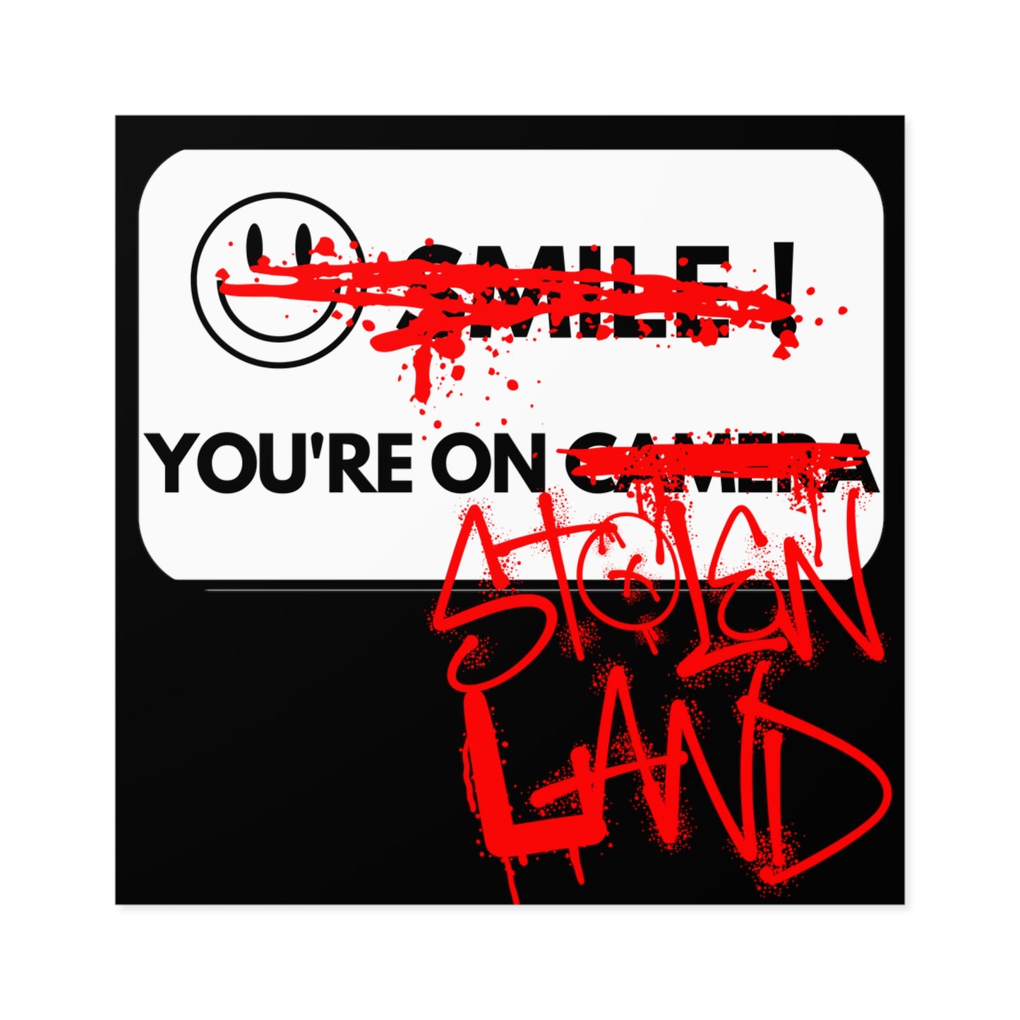 A BLACK STICKER FEATURING A WHITE "SMILE YOU'RE ON CAMERA" SIGN WHERE THE SMILEY FACE AND WORDS "SMILE" AND "CAMERA" HAVE BEEN GRAFFITIED OUT WITH RED SPRAY PAINT AND THE WORDS "STOLEN LAND" HAVE BEEN ADDED AFTER "YOU'RE ON" IN RED SPRAY PAINT