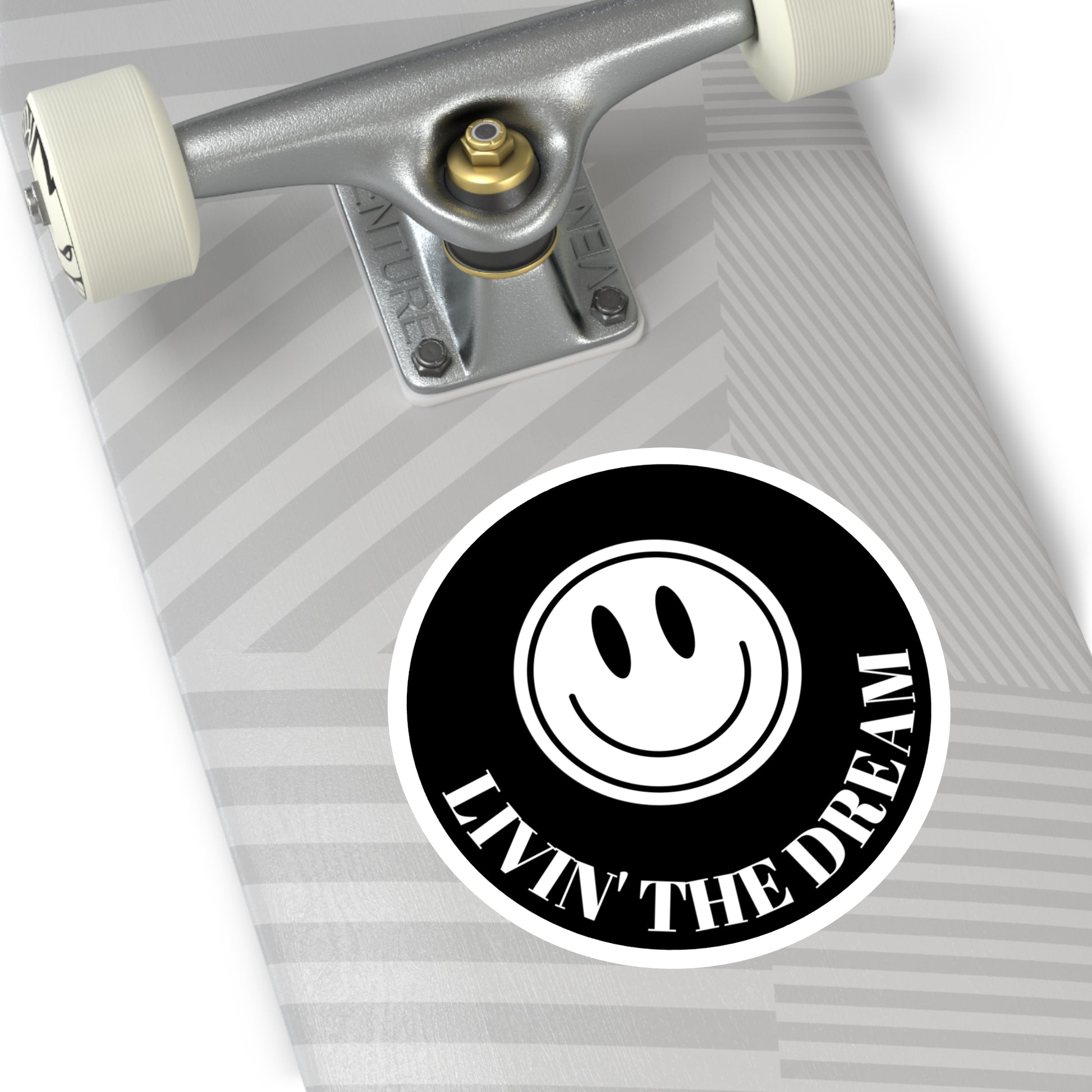 BLACK STICKER WITH A WHITE AND BLACK SMILEY FACE AND WHITE TEXT THAT READS "LIVIN' THE DREAM"